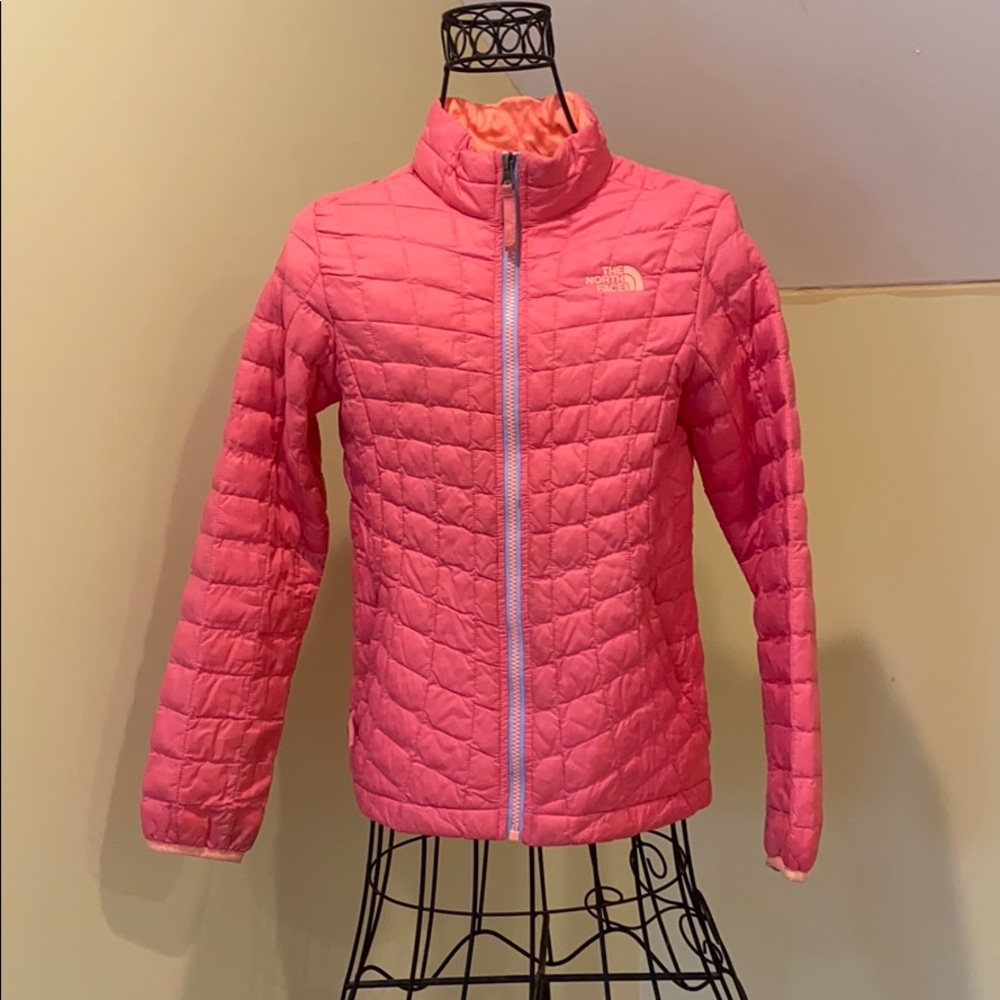 Light pink and orange North Face jacket.